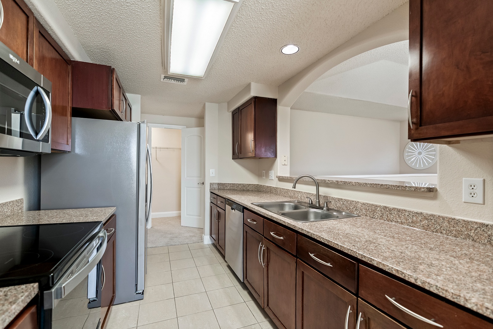 Galley Kitchen with Wood Cabinetry