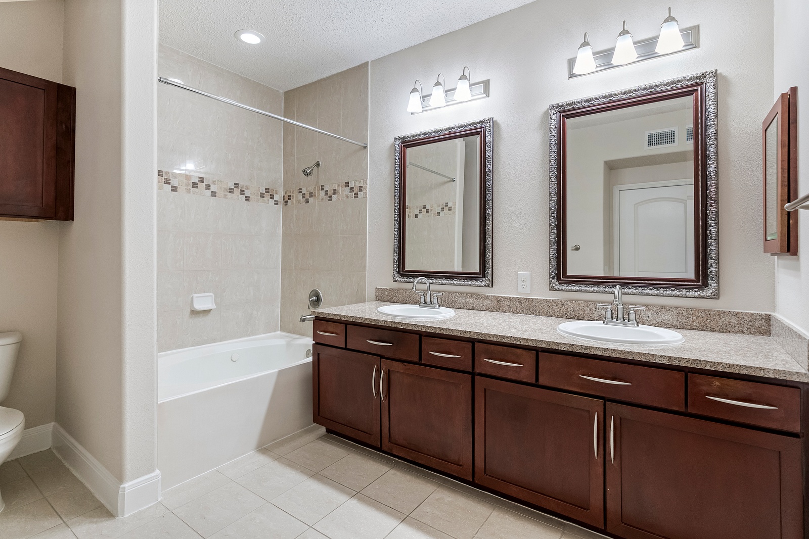 Bathroom with Dual Vanity Sinks and Tub