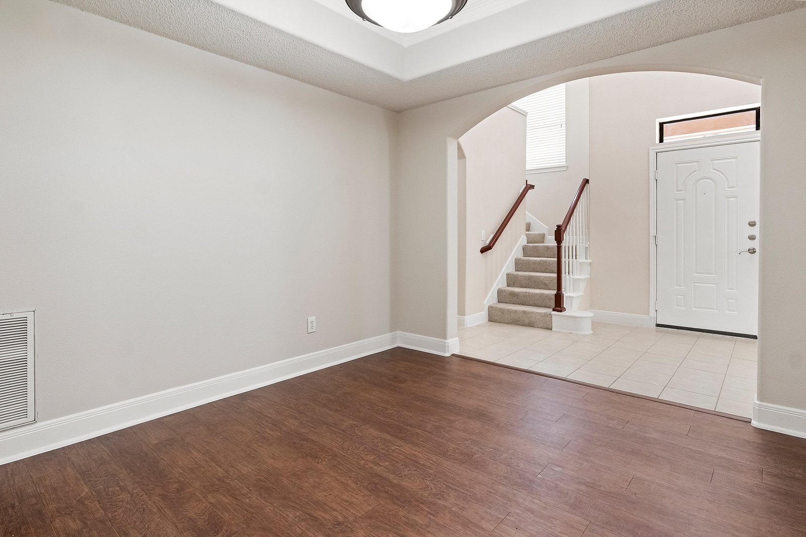 Entryway with Staircase and Tile Flooring