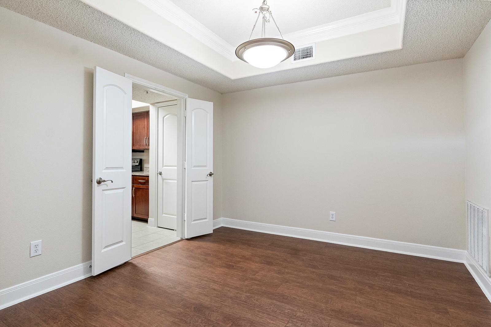 Spacious Bedroom with Tray Ceiling Detail
