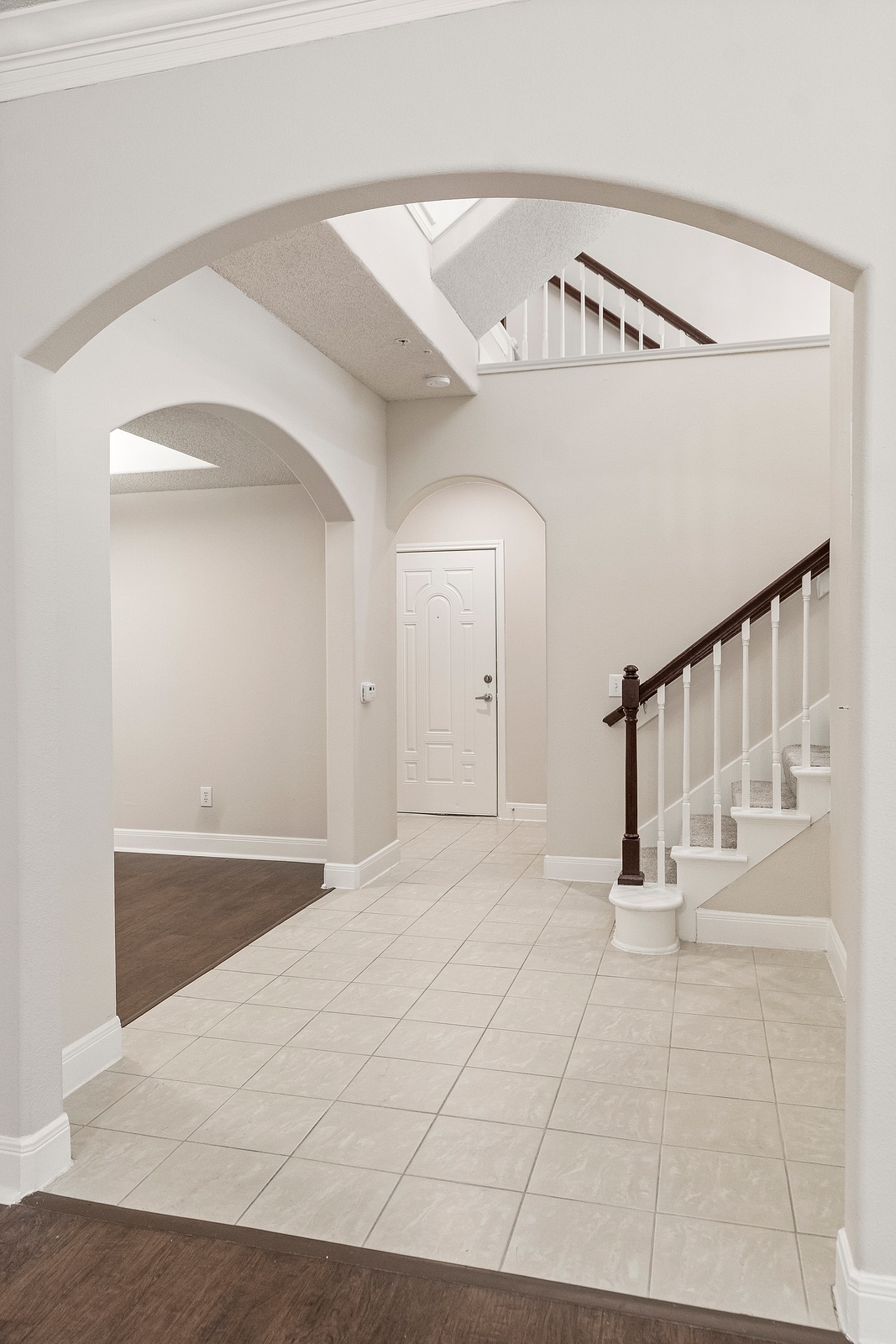Foyer with Archway and Tile Flooring