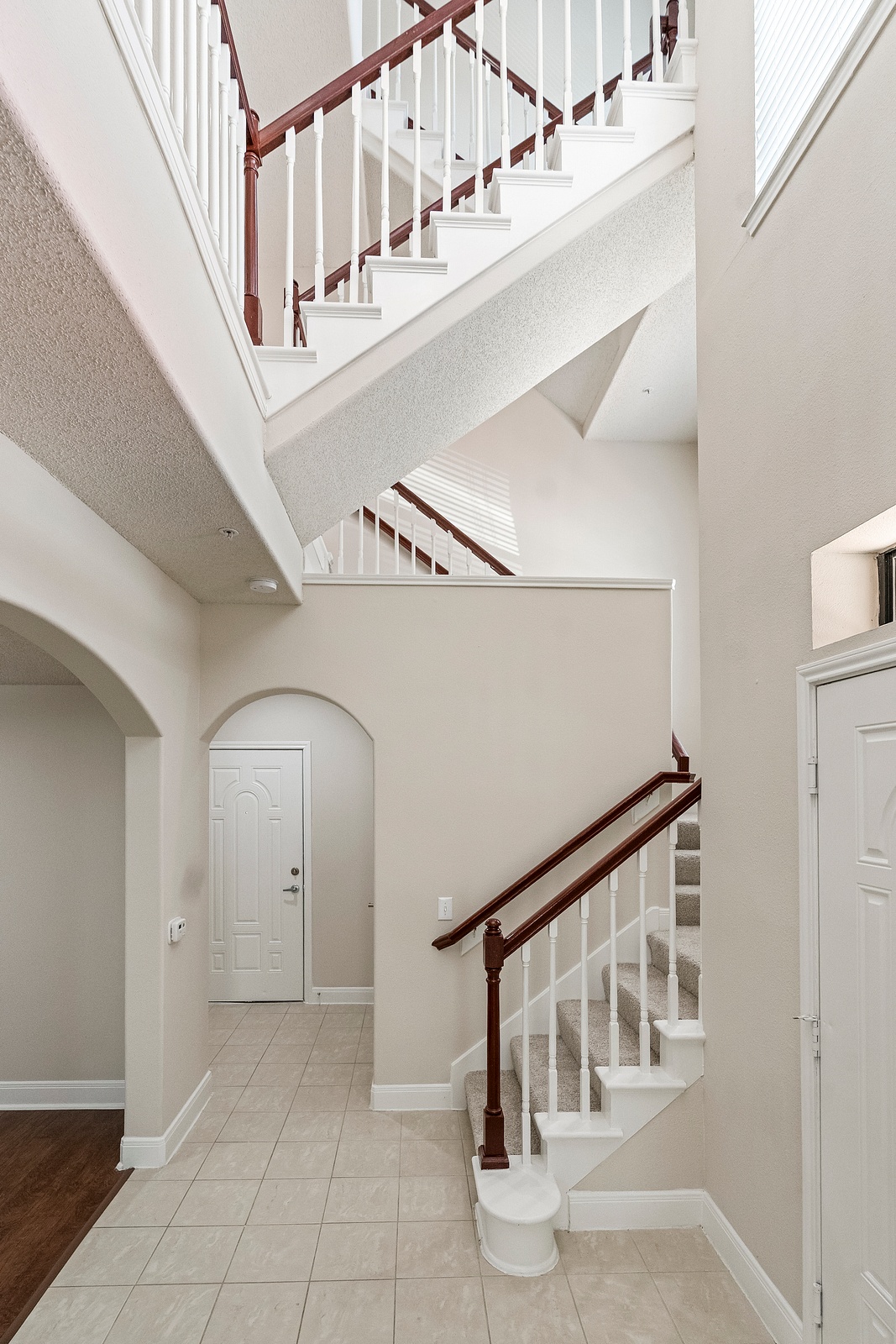 Grand Foyer with Staircase and Tile Flooring