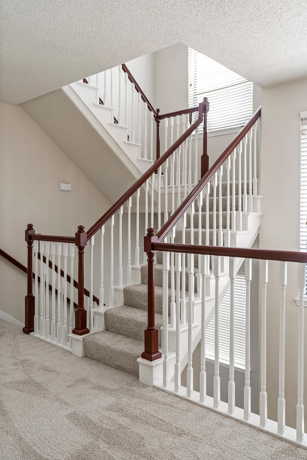 Elegant Staircase with Carpeted Steps and Railing