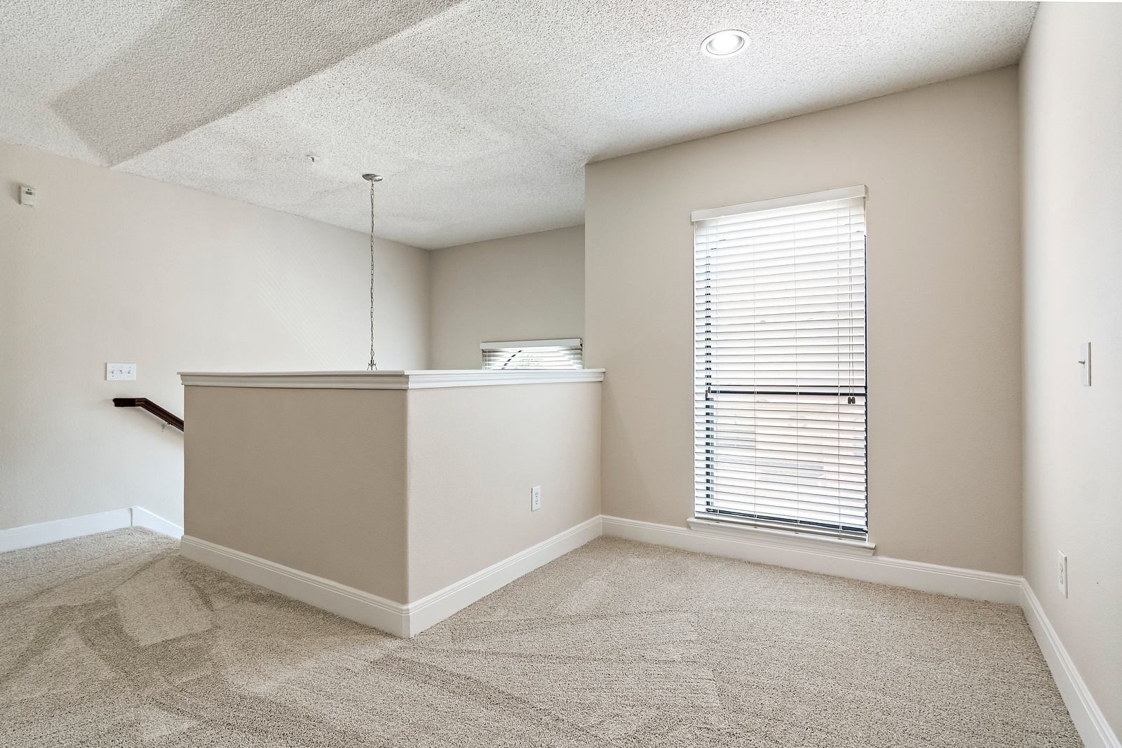 Cozy Loft Space with Plush Carpet Flooring