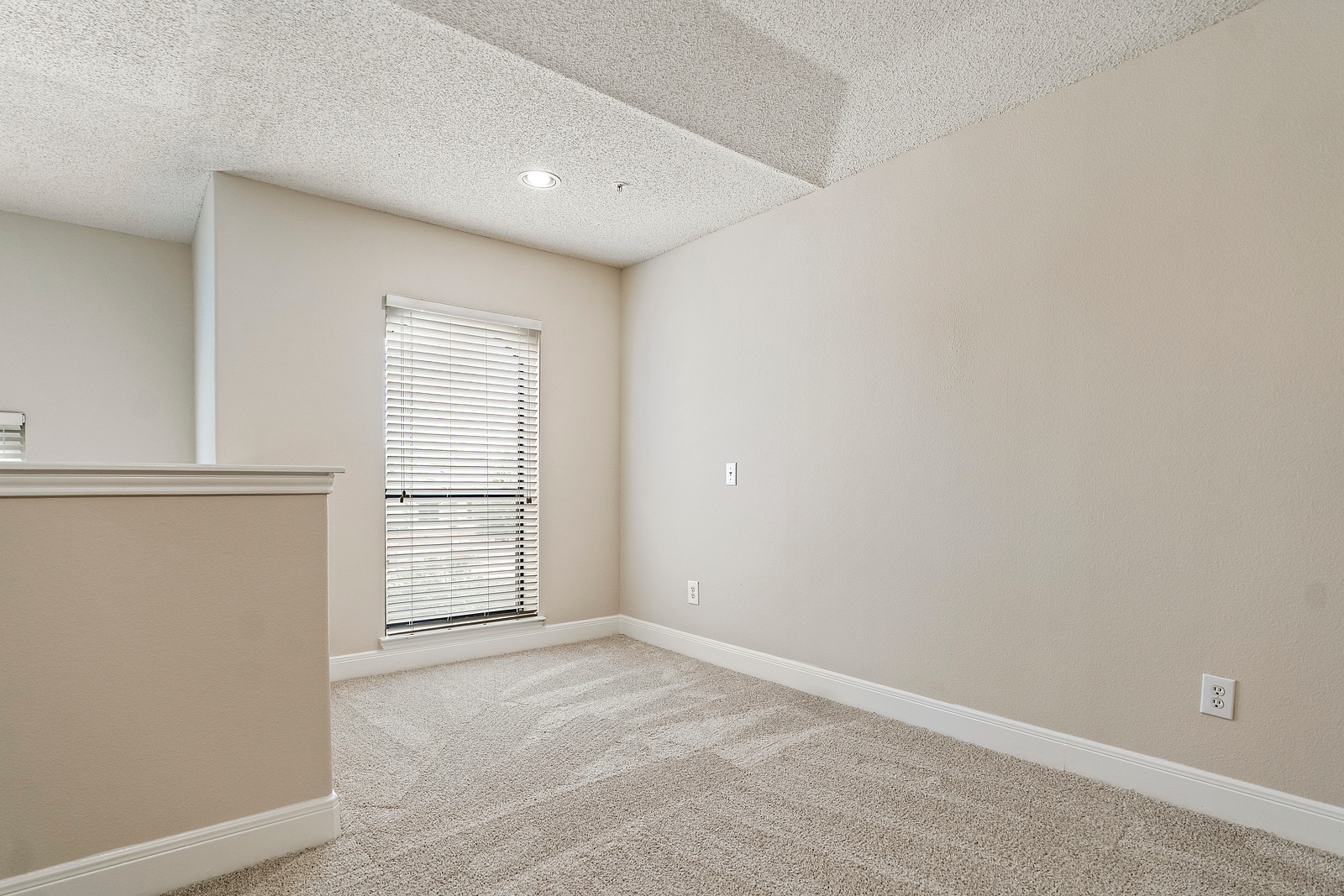 Cozy Loft Space with Plush Carpet Flooring