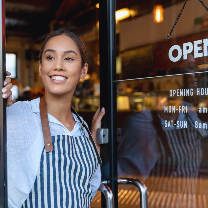 Waitress opening local shop in the morning