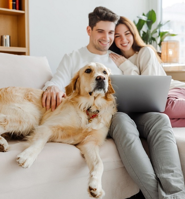 couple with dog on couch