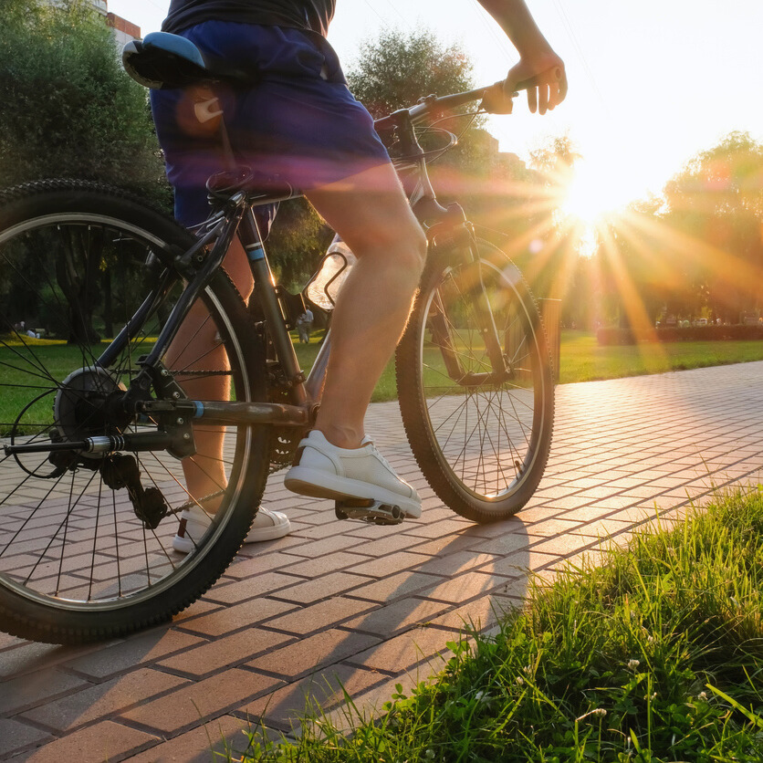 Man biking in the afternoon sunset in full gear at the park