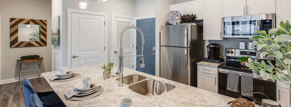 Kitchen with Stylish Breakfast Bar Countertop at The Westport Apartments