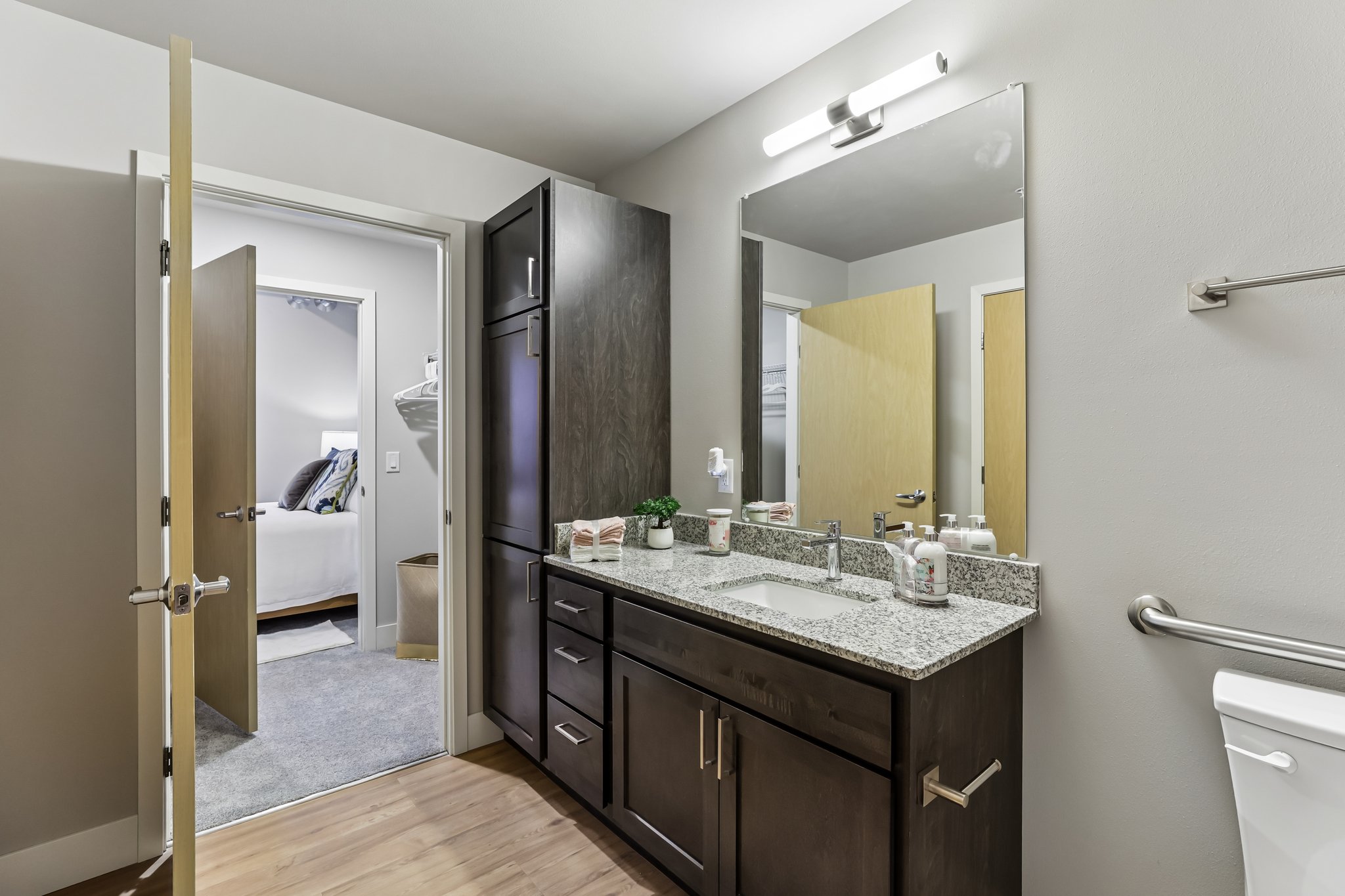 Bathroom in a one-bedroom income-restricted 55+ apartment at The Victoria at Huxley Yards in Madison, WI, with modern vanity and accessible layout.