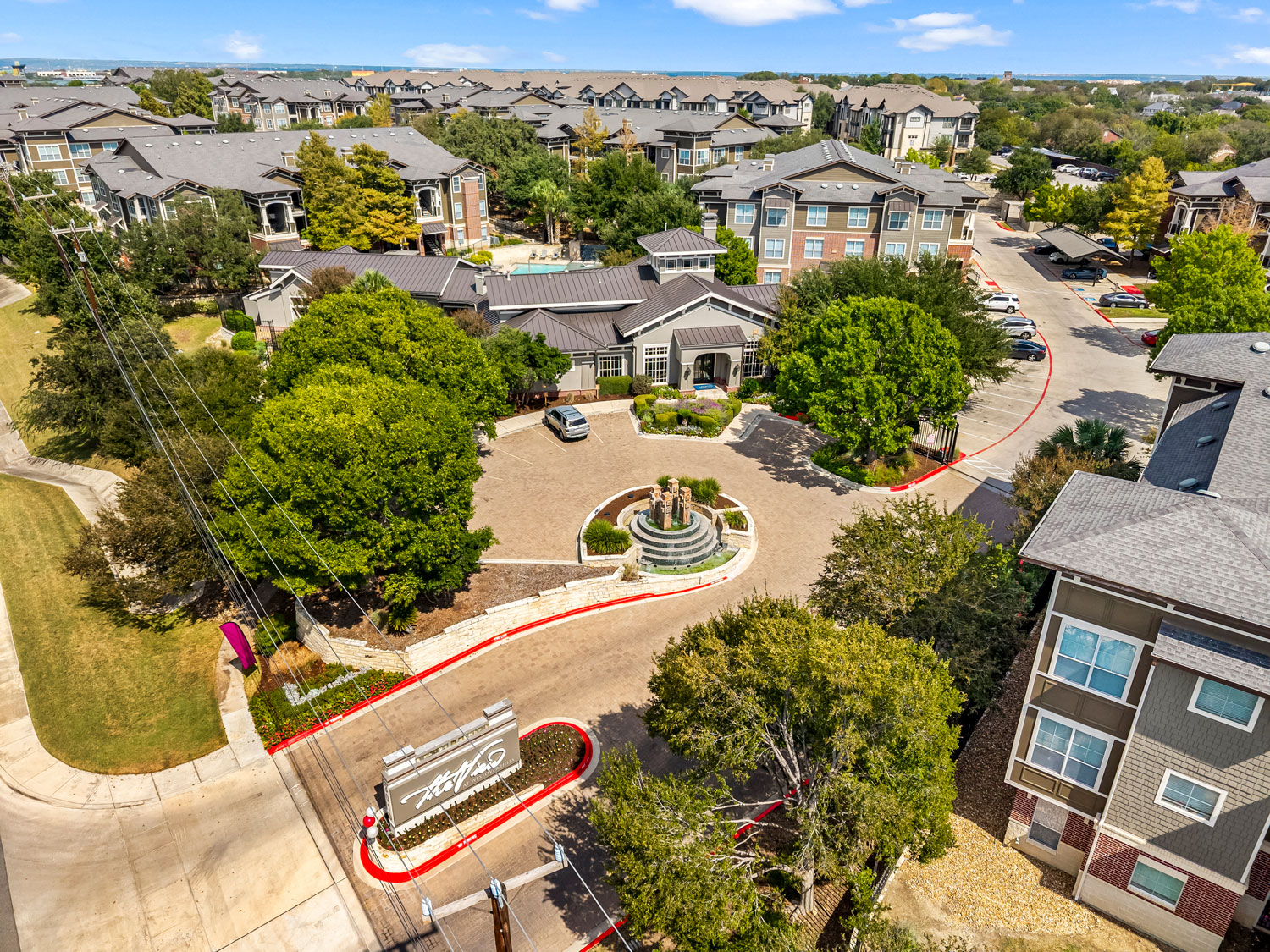 Aerial view of The View at Westover Hills apartment community showing the entrance, fountain, leasing office, and pool