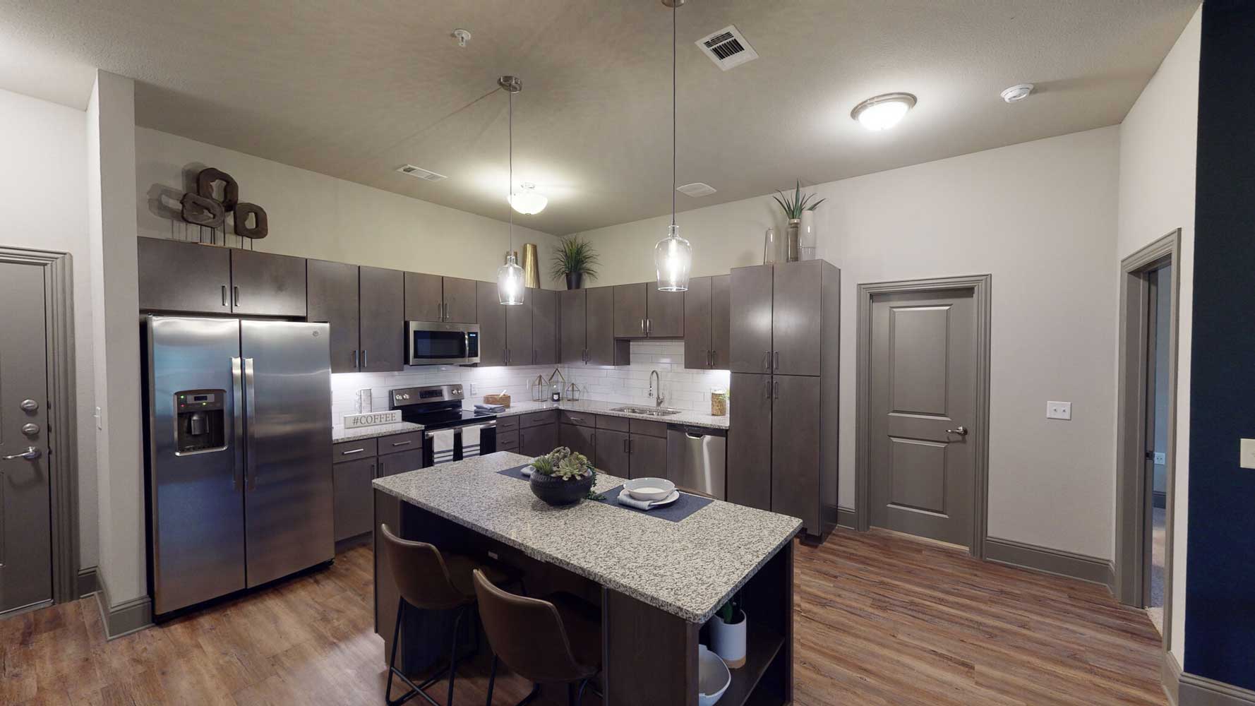 Kitchen with Appliances at The Reatta Ranch Apartment Homes in Justin, TX