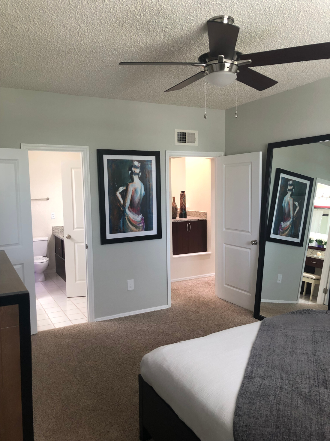 Bedroom, comfort room and a body mirror at Waterford Point Apartments in Miami, Florida