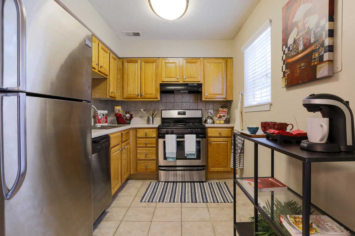Kitchen W/ Ample Wooden Cabinetry at Wildwood Ridge Apartments