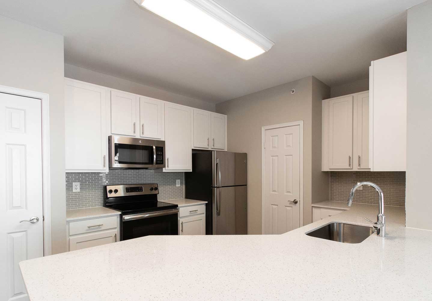 Kitchen with White Cabinetry in Select Units at Windward Place Apartments