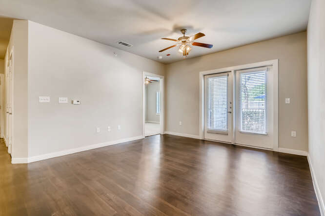 Living Room With Ceiling Fans at Woodcreek Apartments In Wimberley, TX.