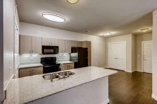 Kitchen With Counter-top at Woodcreek Apartments In Wimberley, TX.