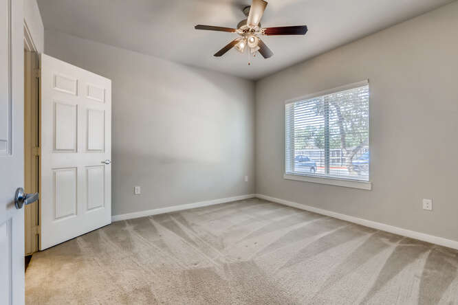 Bedroom With Ceiling Fan at Woodcreek Apartments In Wimberley, TX.